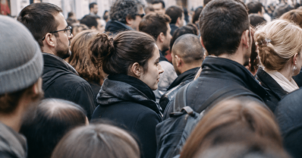 Foule dense de personnes debout serrées ensemble dans rue